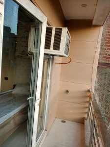 A picture of balcony with door and air condition of UCH girls PG in Delhi