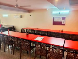 A picture of food court area with dining table, chair, air condition and fan of UCH Girls PG in Kamla Nagar Delhi