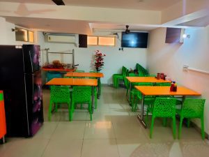 Dining room of girls PG in Delhi with dining table and chair