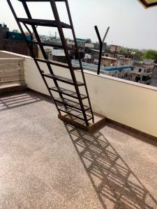 A picture of roof top with a iron staircase of UCH Girls Hostel In Delhi